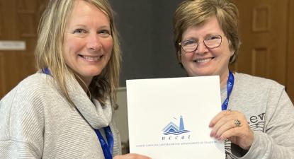 Ms. Renee Bunn (left) is pictured receiving her award from Kim McWhirter (right), presenter for the program.