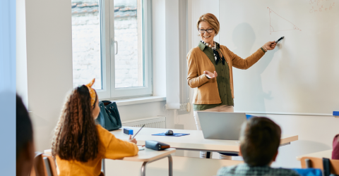 Teacher teaching math in classroom.