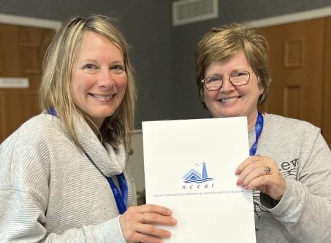 Ms. Renee Bunn (left) is pictured receiving her award from Kim McWhirter (right), presenter for the program.