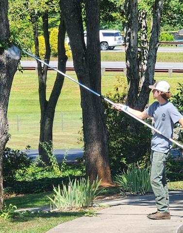 Smoky Mountain High School student Jackson Bowers assist with grounds work at NCCAT Cullowhee campus.